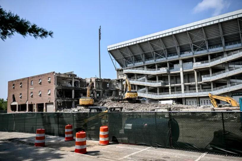 The Central Services Building half destroyed with Spartan Stadium in the background