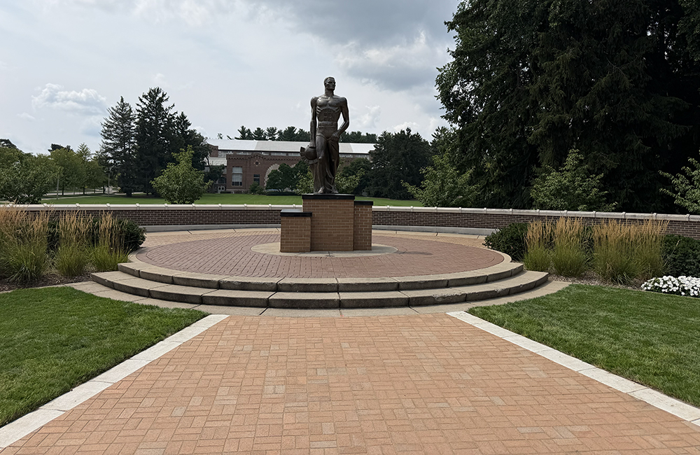 new brick platform leading to the Spartan Statue with a blue sky in the background
