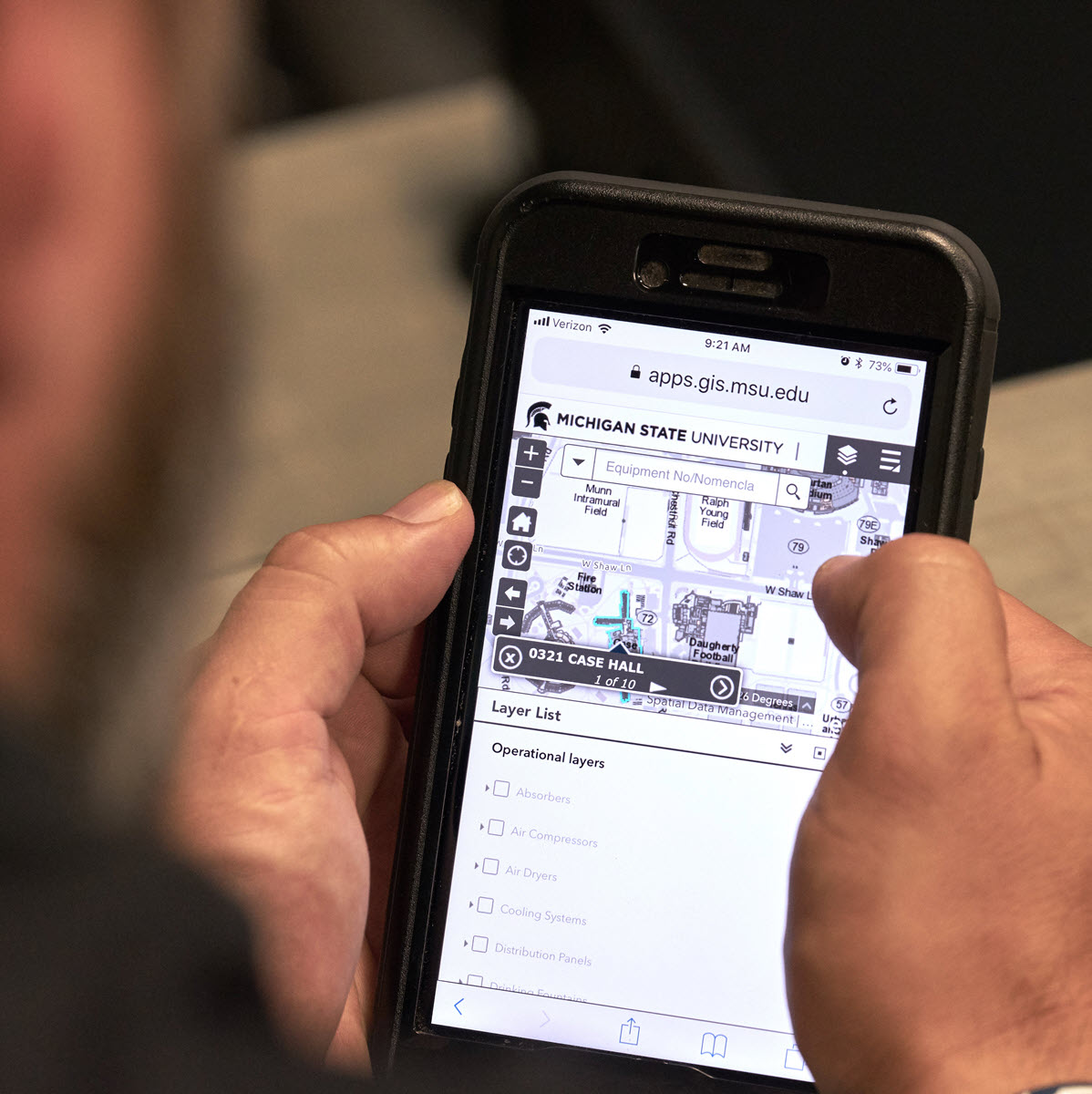 IPF staff member looking at building map information on mobile phone