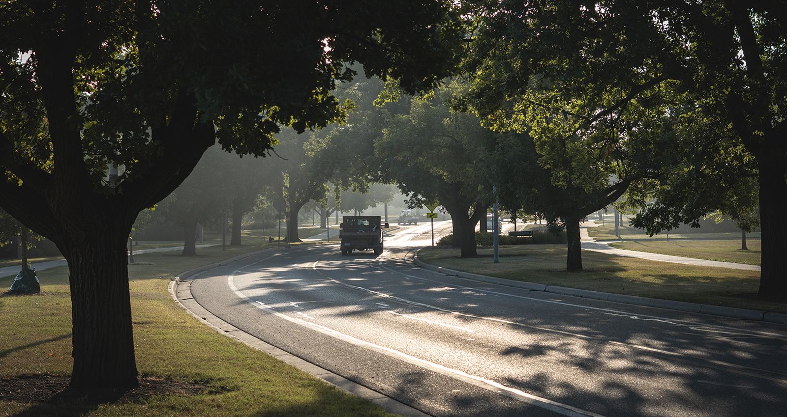 MSU IPF truck driving down the road with trees surrounding the road