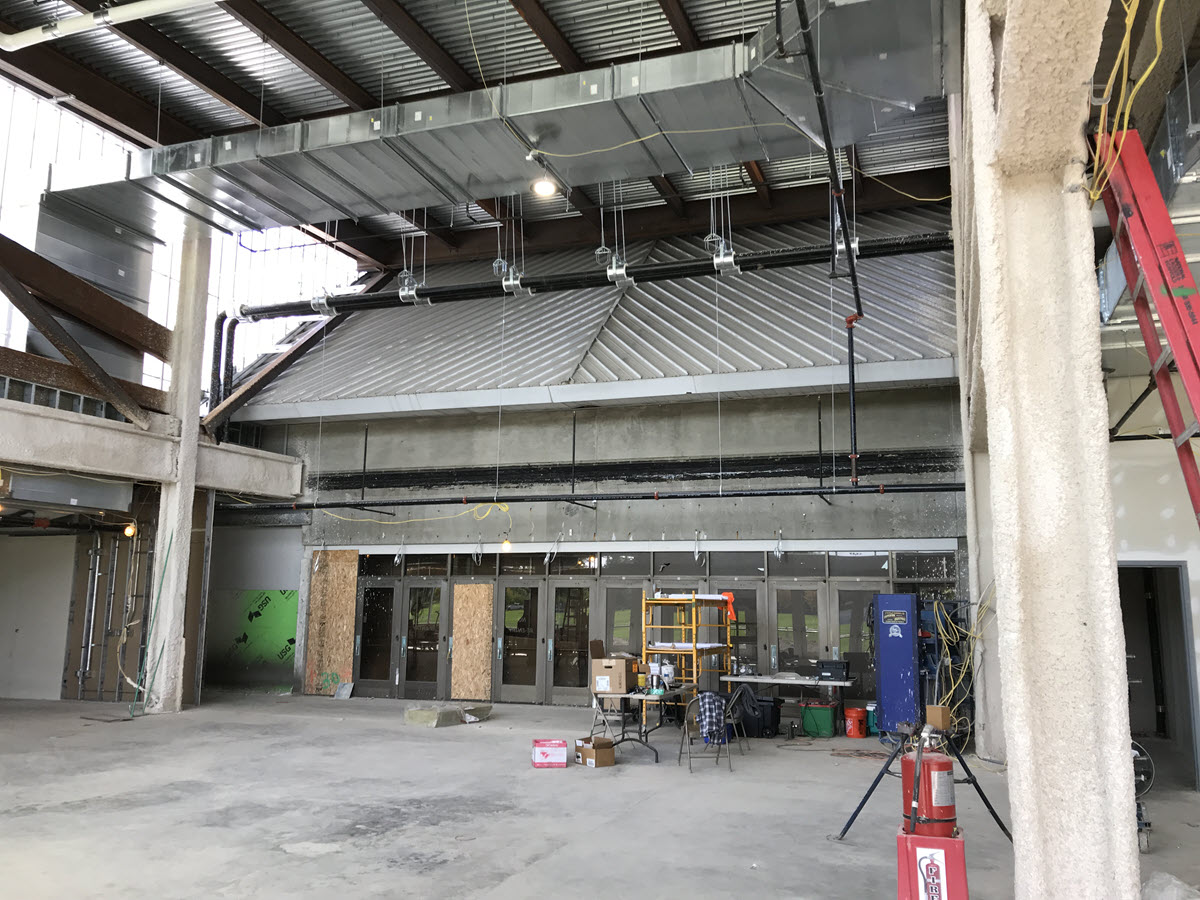 Interior of new addition looking north to existing arena entrance doors