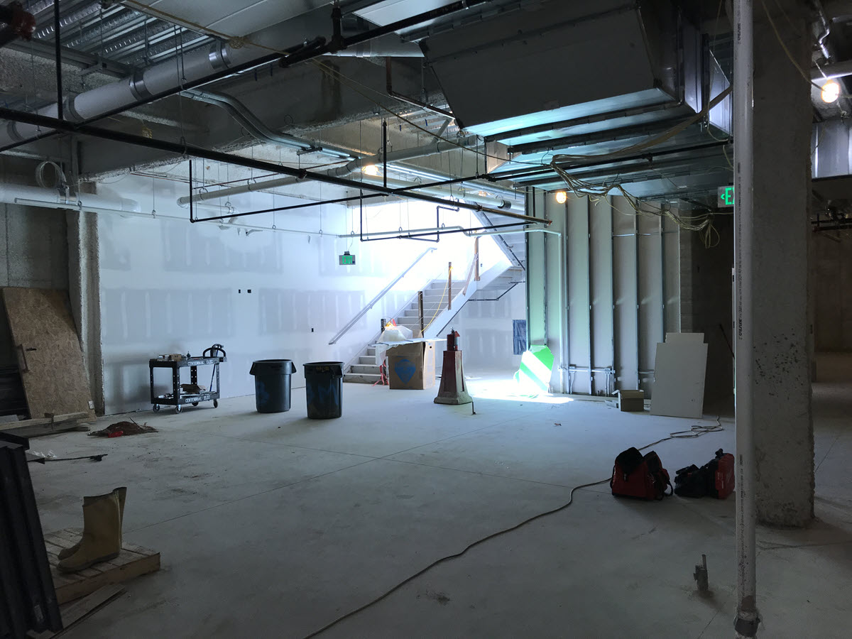 Lower level area that will eventually house player lounge with easy access to west exit stairwell