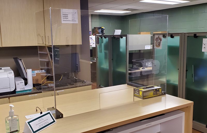 Photo of the plexiglass protective shield installed at the IPF 123 office help desk