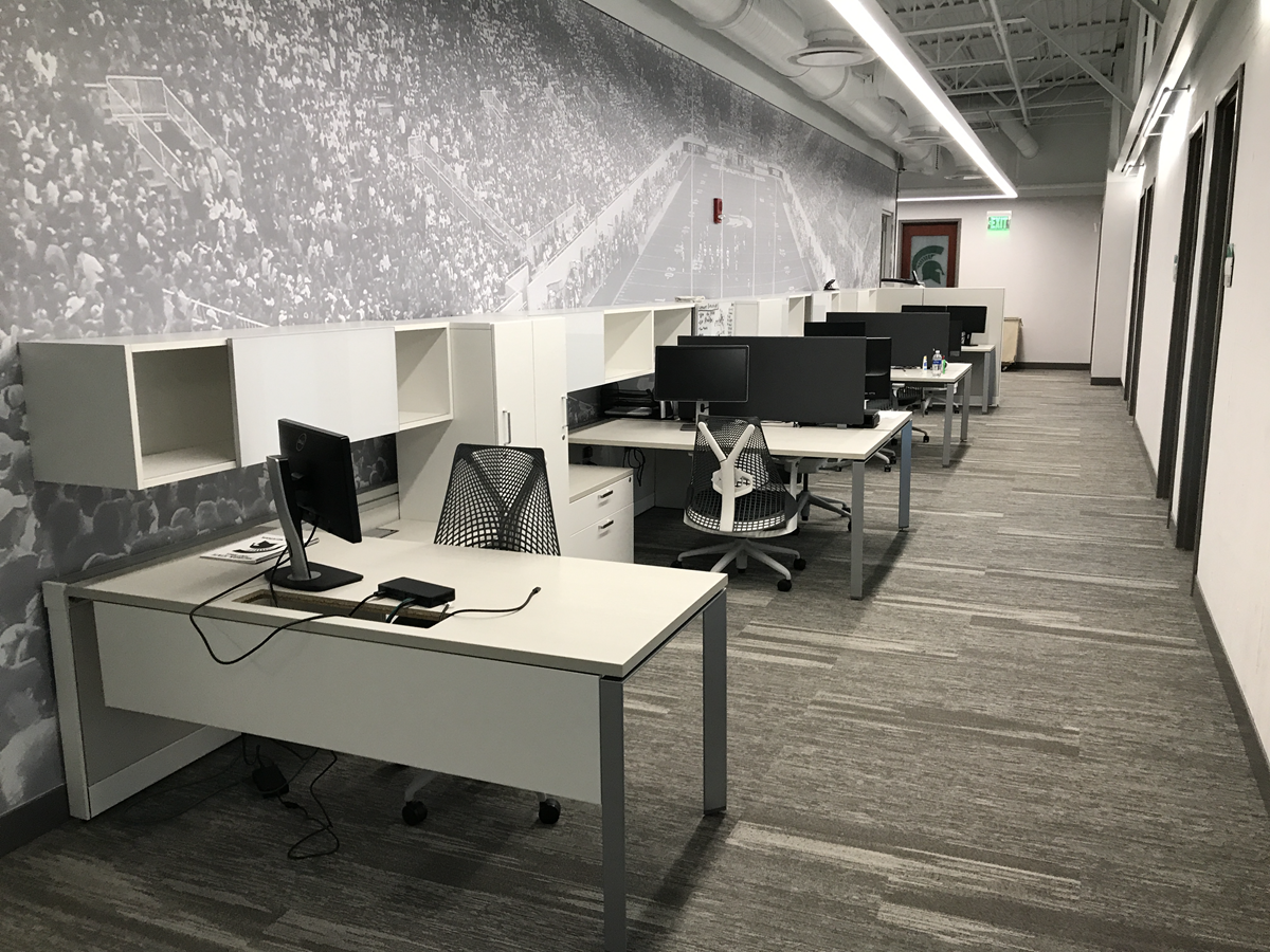 Photo of one of two cubicle rows that flank center conference room