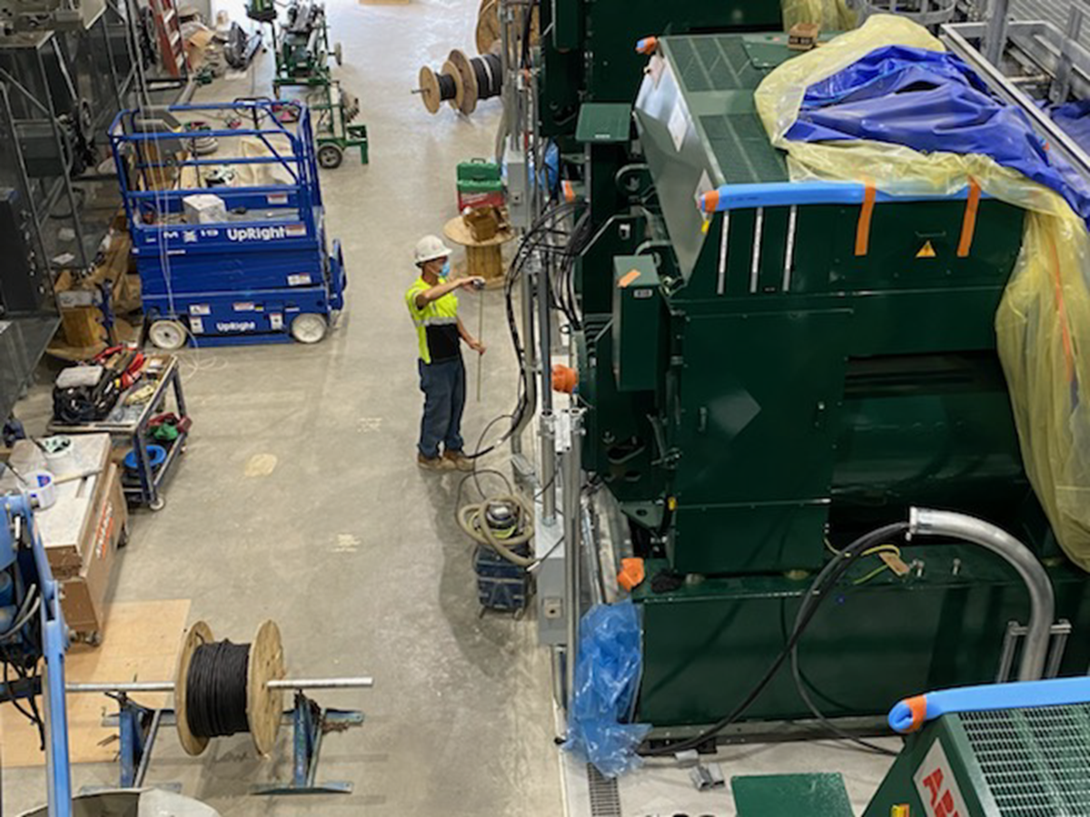 Interior photo showing crew member working on one of the RICE units