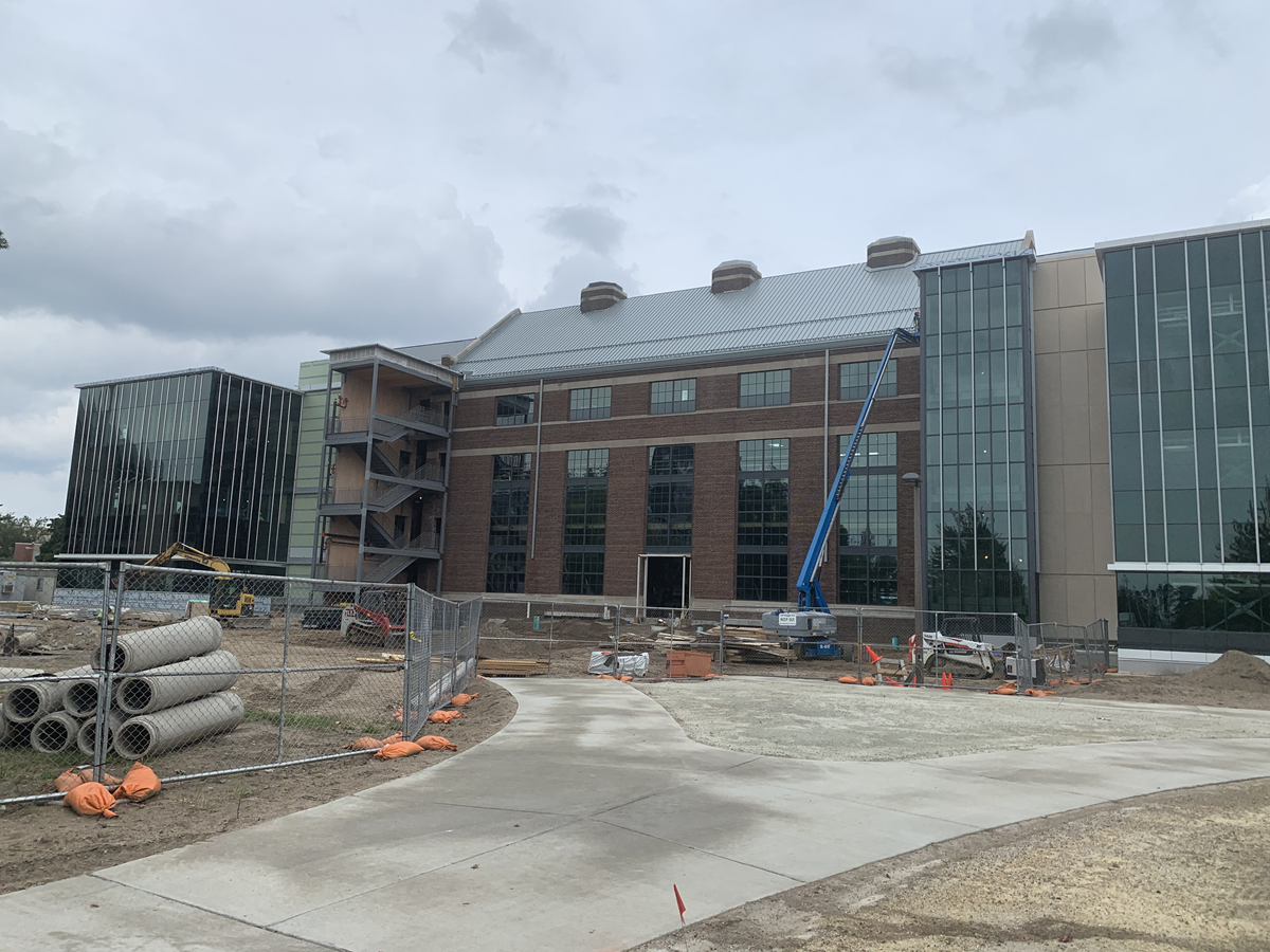 Photo of west side of construction site showing roofing and window work on old Shaw Lane Power Plant section