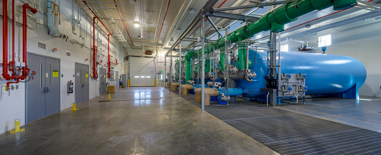 Inside water filtration plant with view of tanks and pipes