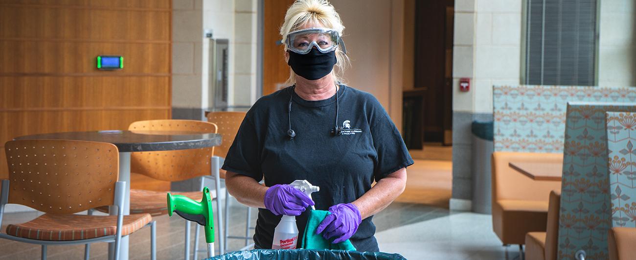 IPF custodian cleaning a campus workspace