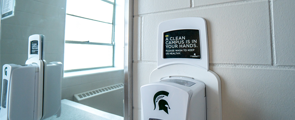 Soap dispenser signage requesting users to thoroughly wash their hands