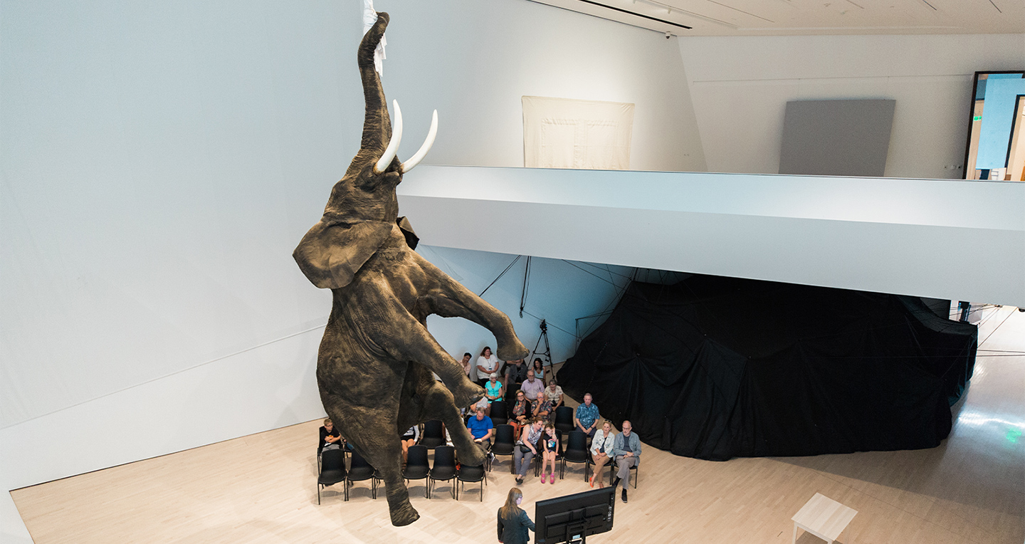 Faux elephant hanging from museum ceiling