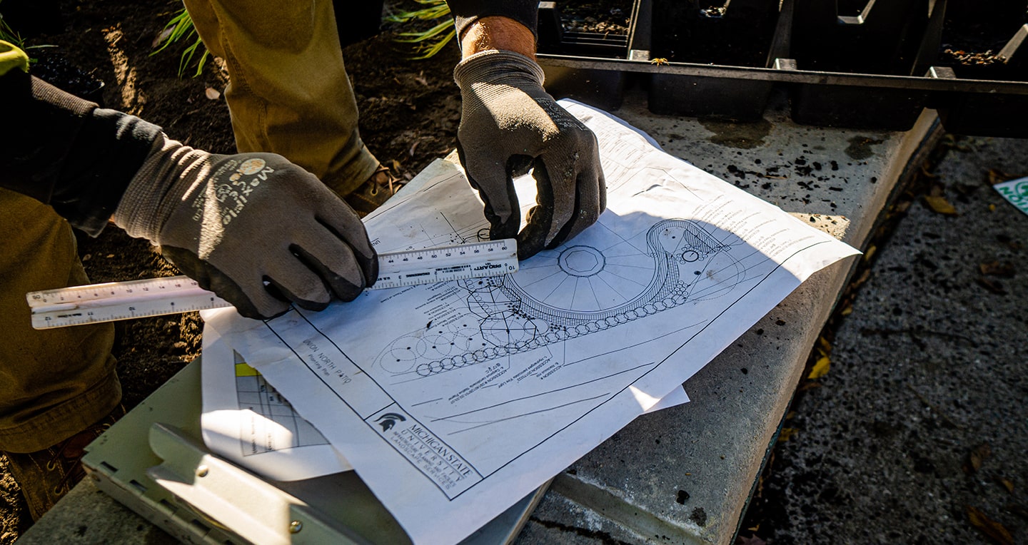 MSU Landscape Services measures landscape plan for MSU Union patio