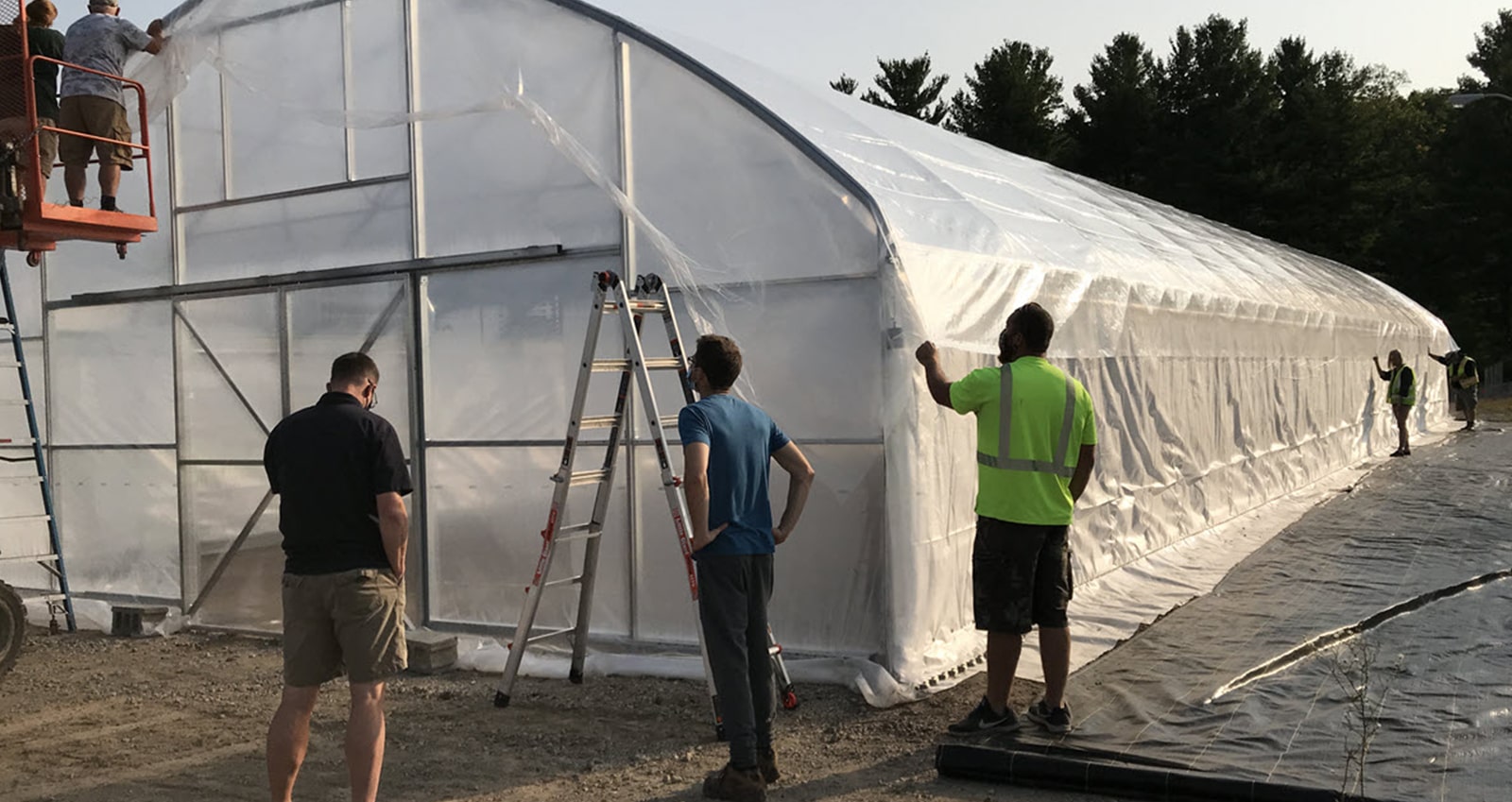 SSRC Team Installing Plastic Cover to Hoop House