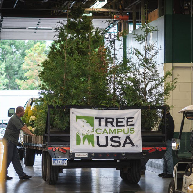 Landscape Services homecoming float featuring their Tree Campus USA banner