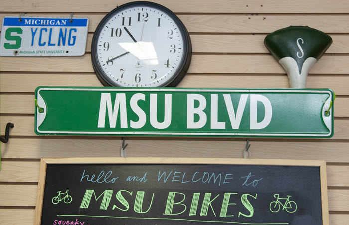 Photo of wall above MSU Bikes service counter showing miscellaneous bicycle-related materials