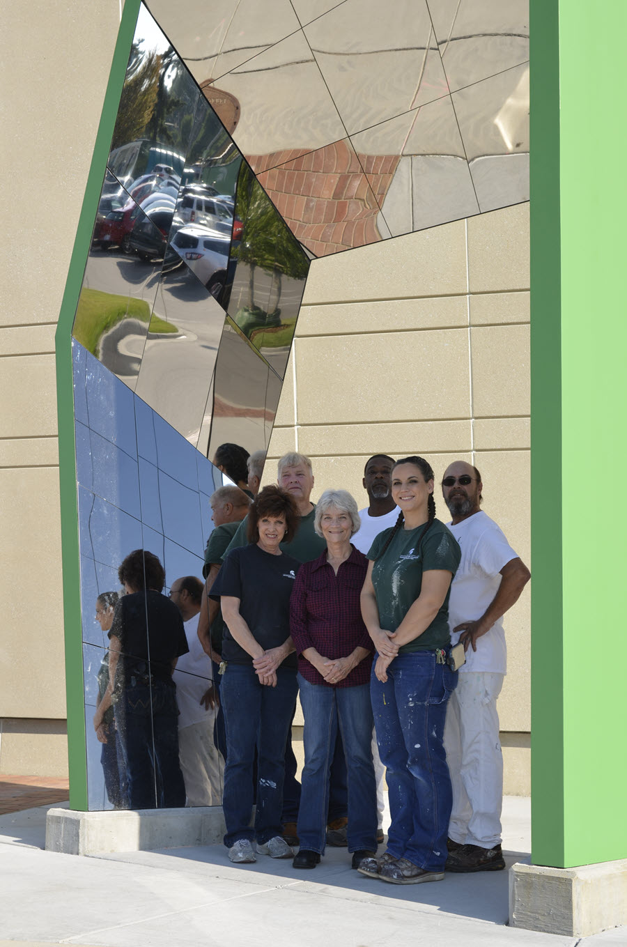 Photo of Paint Shop crew standing inside of campus art installation at Spartan Stadium