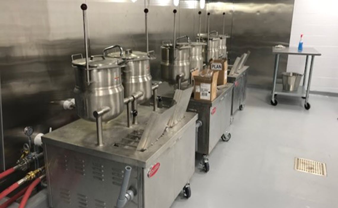 Pilot Plant kitchen - mobile steam kettles piped below capture hood