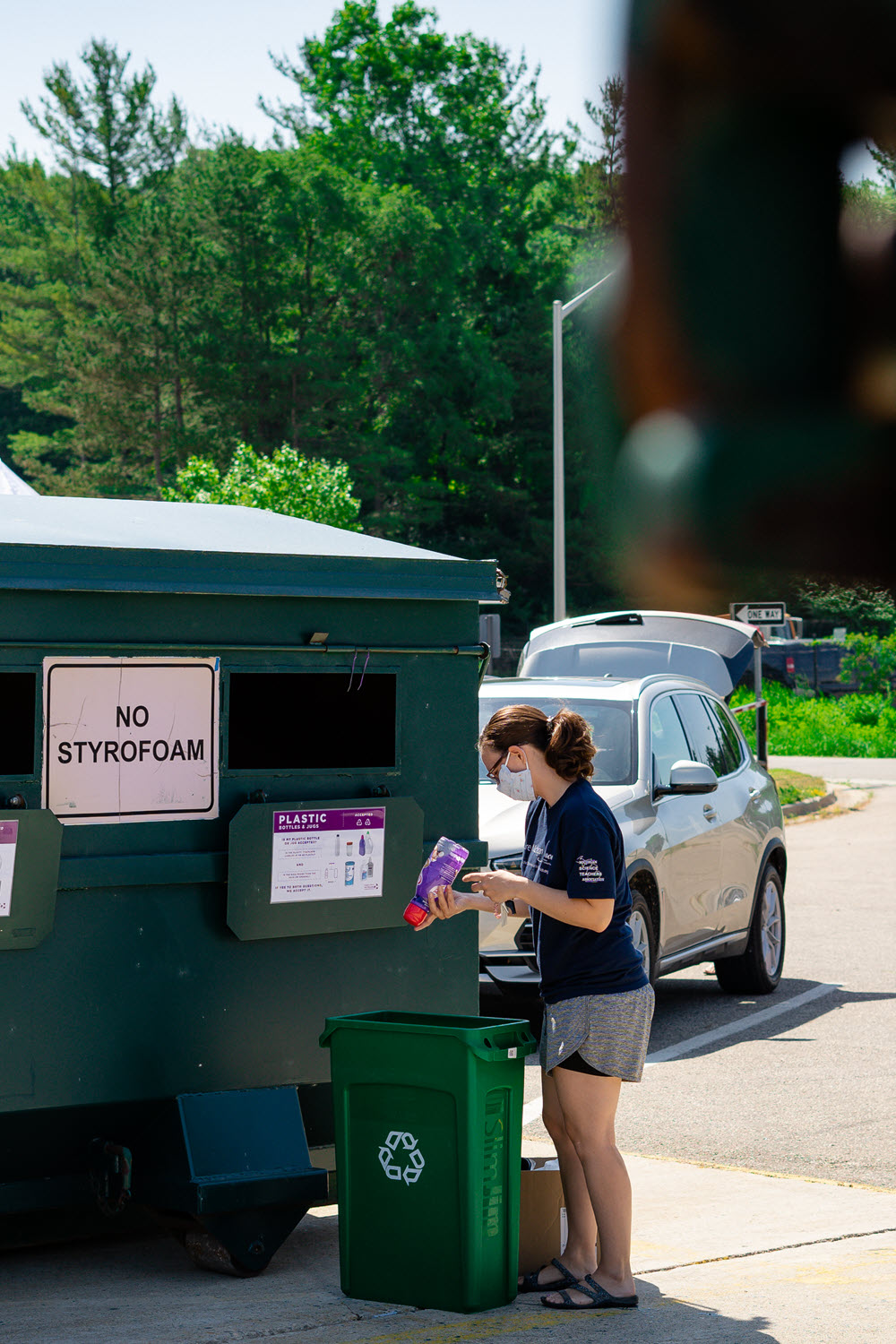 Woman recycling plastic at the MSU Drop Off Center