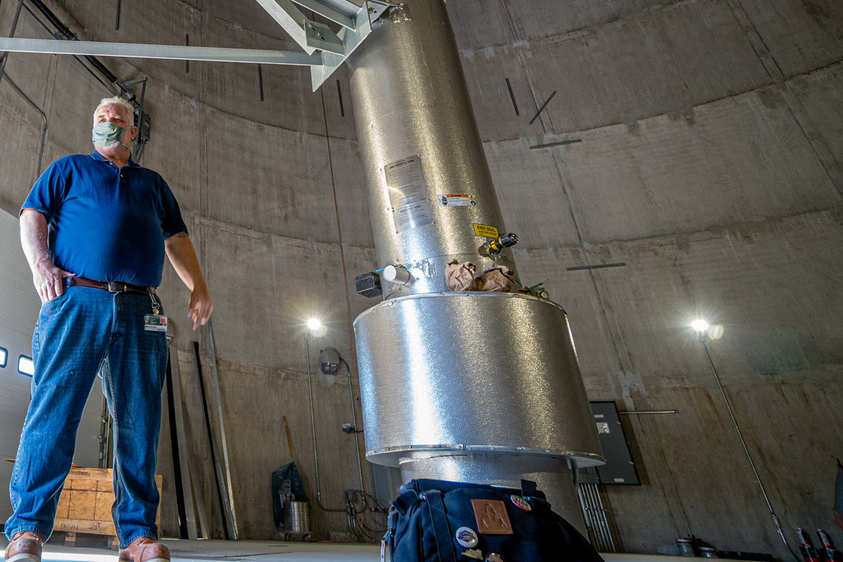 Photo of Tom Silsby standing inside bottom of storage tower base