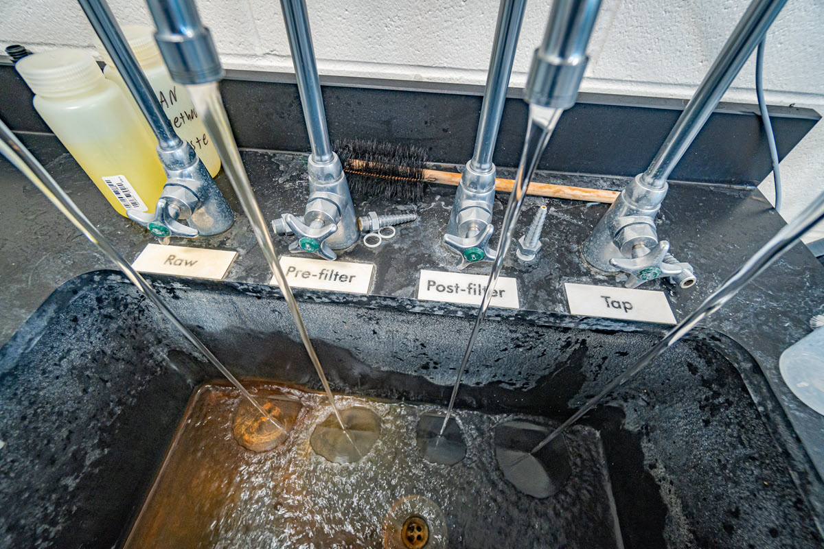 Photo of testing faucets at the Water Treatment Plant lab, showing the improvement in water aesthetics as the water travels from well source through treatment and finally at end of treatment