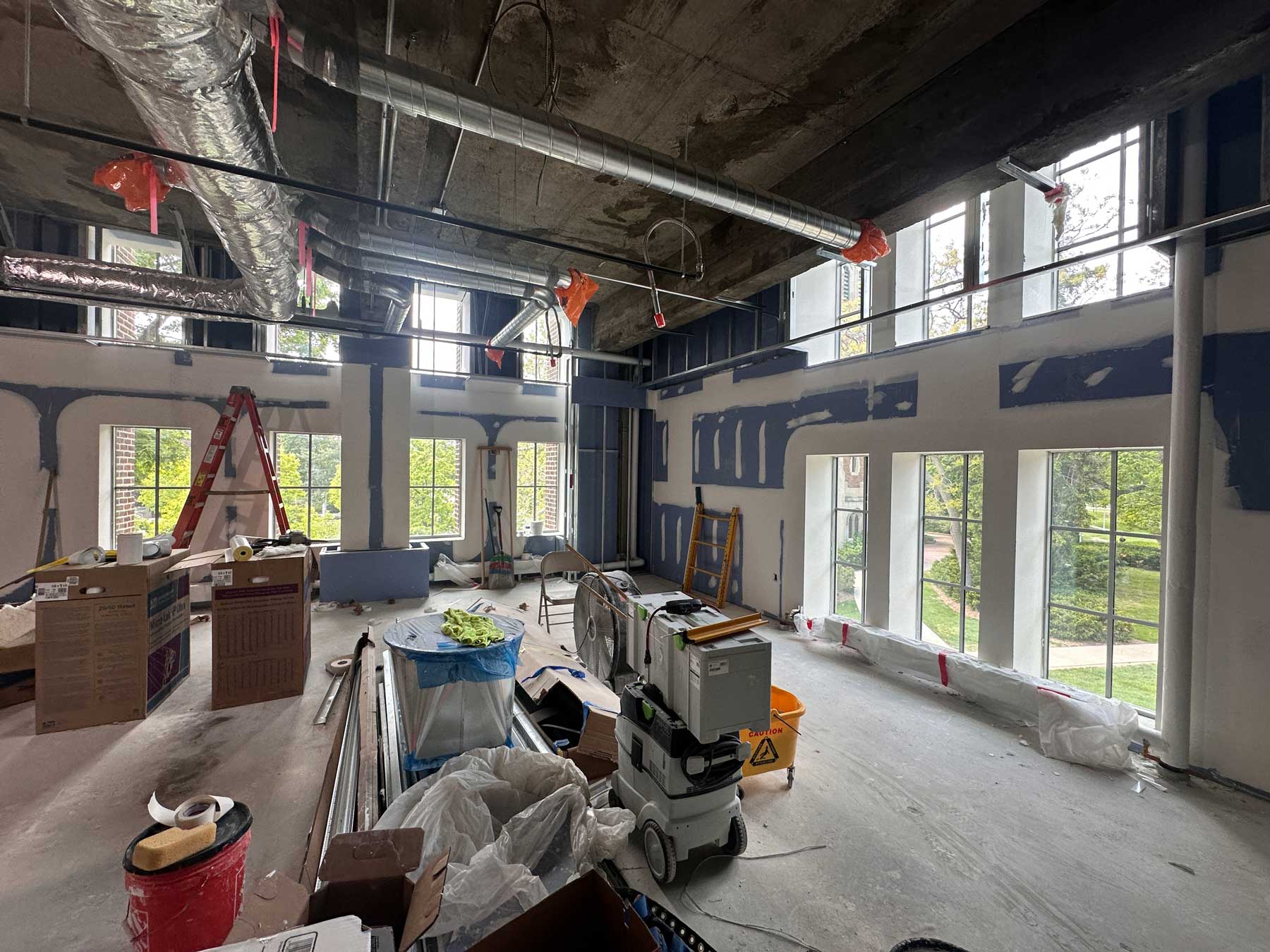 interior of museum renovations with taped and mudded drywall and exposed ceiling HVAC
