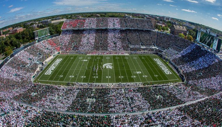 Thousands of spartan fans dress in green and white at Spartan Stadium.
