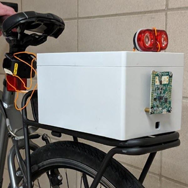 Photo of prototype collision avoidance device mounted to back of bicycle