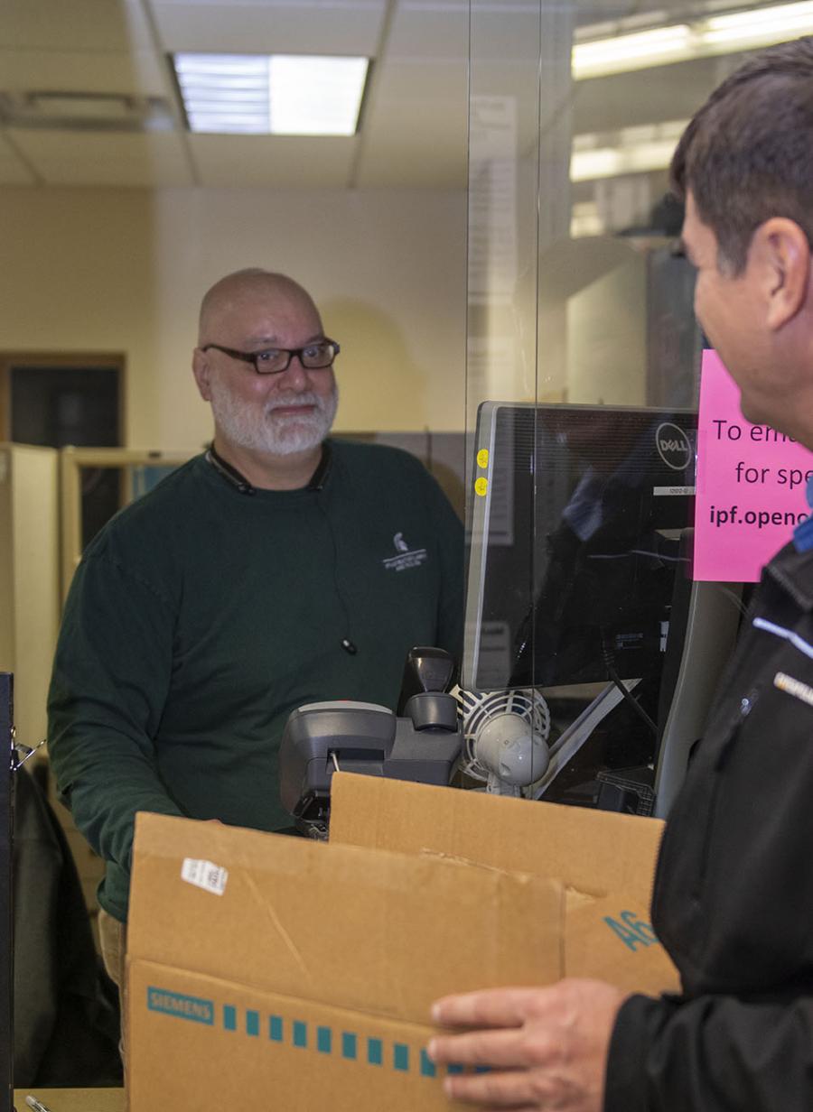 photo of ruben garza assisting unidentified customer