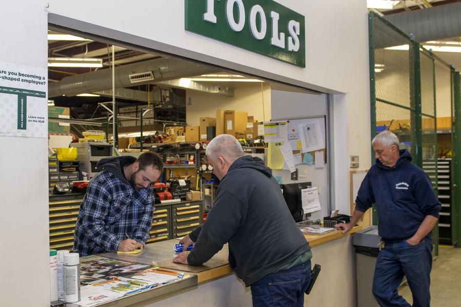 Photo of nick brisbin assisting unidentified customers at the tool counter