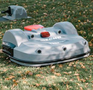 Photo of roomba like mowing machine in grass by Brody Hall