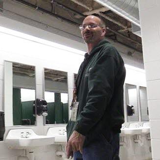 Photo of IPF plumber Bert Skowronski inside of one of Spartan Stadium's bathrooms