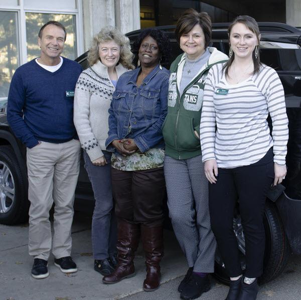 Transportation Services Motor Pool Staff standing in front of lease vehicle