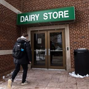 Photo of student walking into the Dairy Store outside entrance