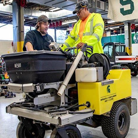 Landscape Services staff examining equipment