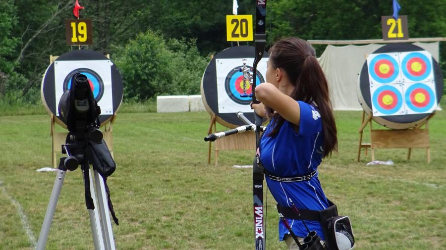 Woman shooting an arrow at a target