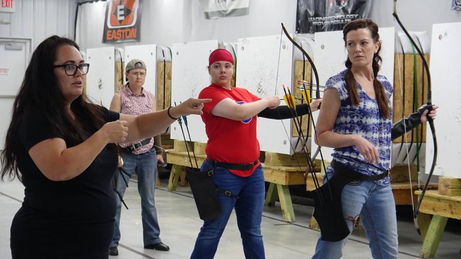 People practice archery at the Demmer Center