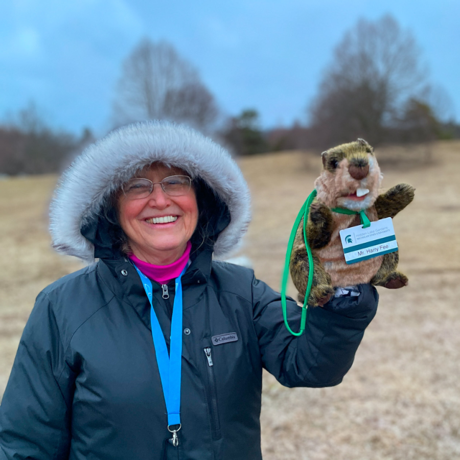 Hidden Lake Gardeners Club President, Julie Hewlett, with HLG resident groundhog.