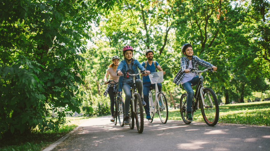 A family of bikers ride through the Gardens.