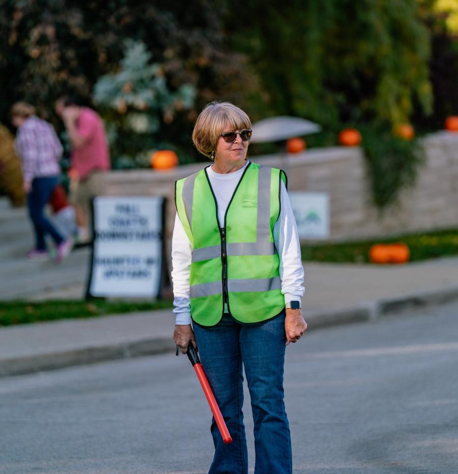 A volunteer directs traffic at HLG.