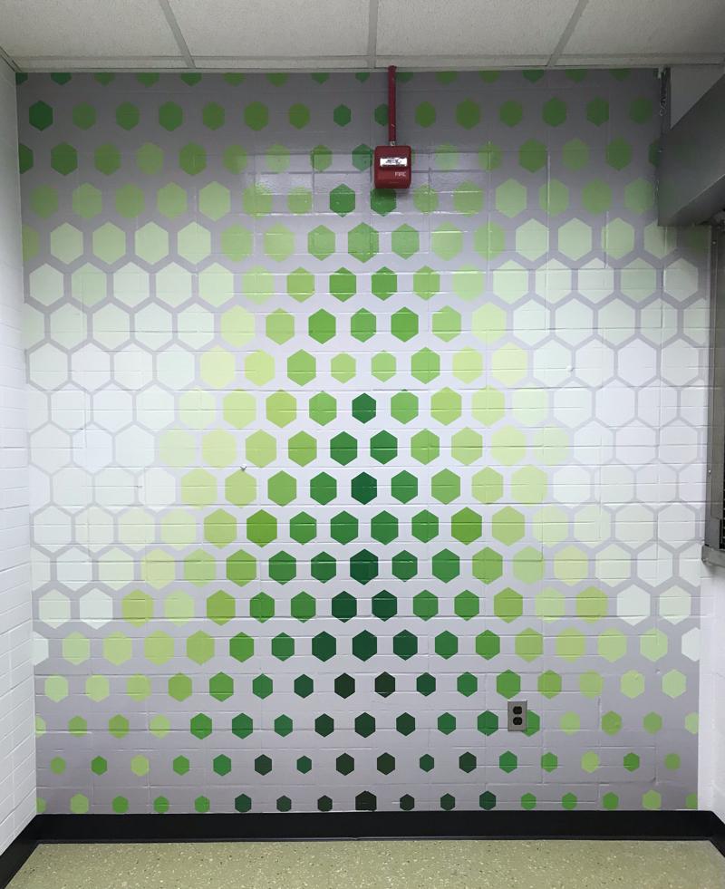 Wall of green and white hexagons in Linen Services