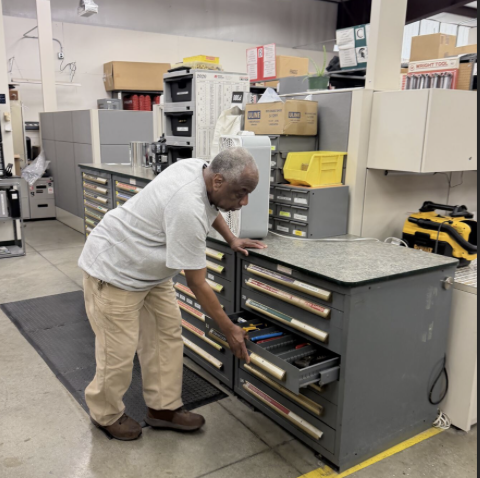 Robyn Perry opening a gray cabinet drawer