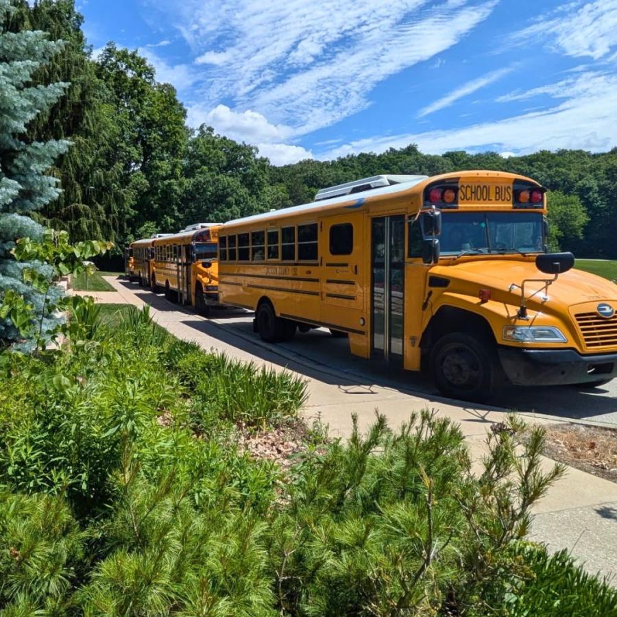 School buses lined up in front of the Visitors Center