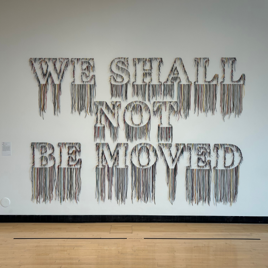 A sculpture displays the words “WE SHALL NOT BE MOVED.”