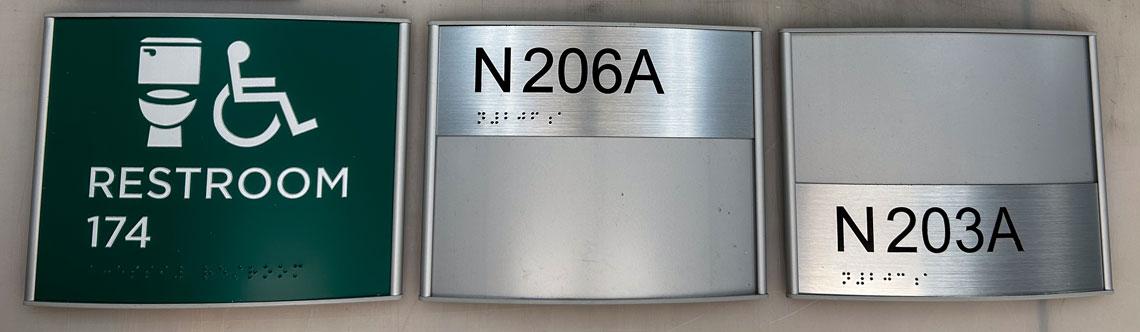 Three blank door signs on a table