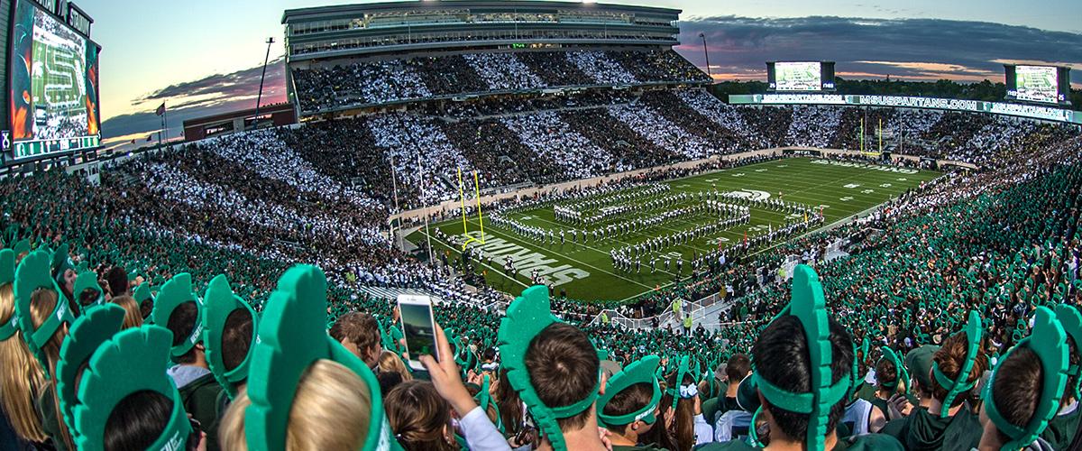 Students cheer on the Michigan State Spartans to victory at Spartan Stadium.