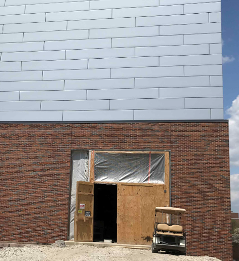 Exterior metal panel and brick installations