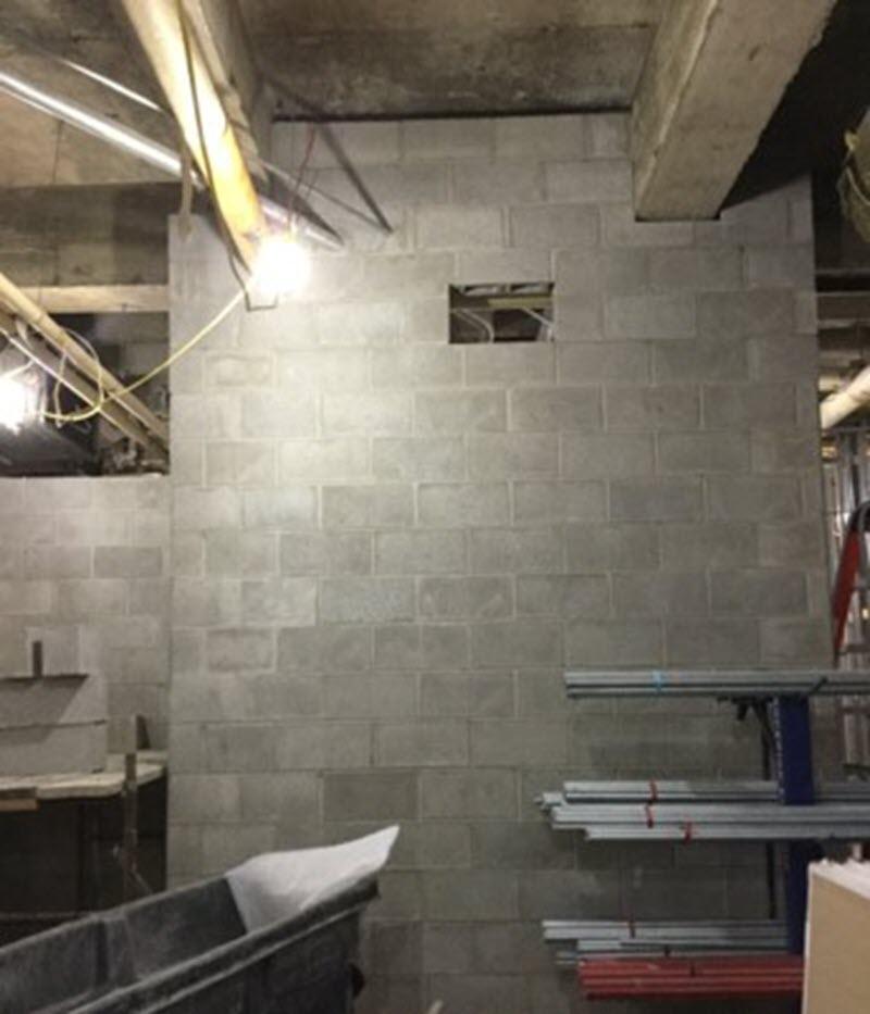 New concrete masonry unit walls in the center of locker room