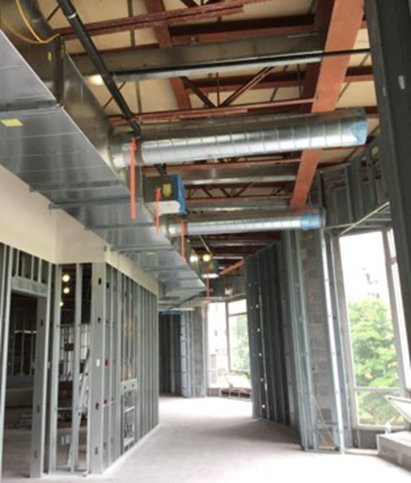 New ductwork and overhead drywall in the second-floor hallway