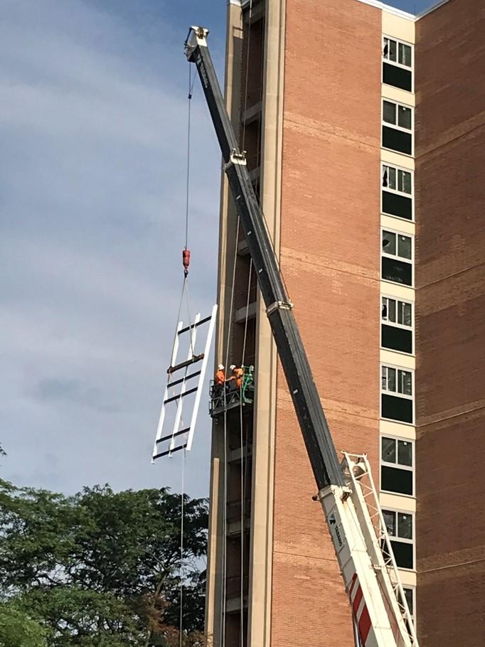 Lifting window frame into the stairwell for the completion