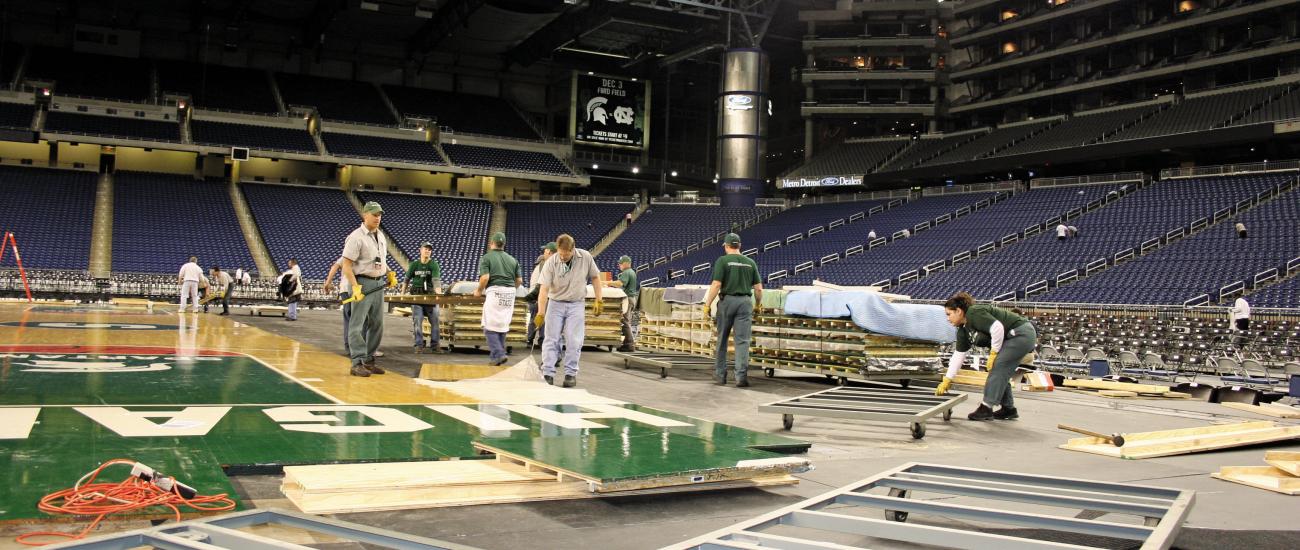 Set up crew installing men's basketball court flooring