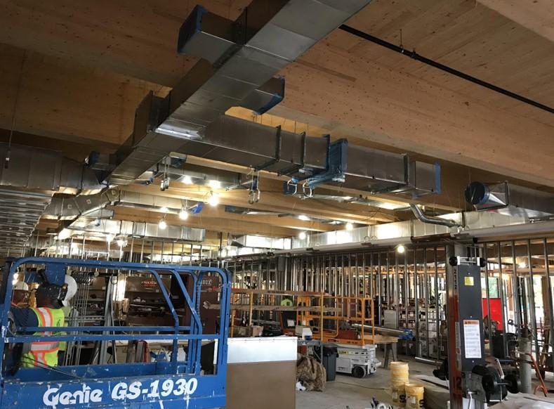 South STEM showing the mechanical system installation and exposed mass timber ceiling